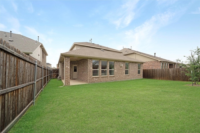 911 Bluewood St, Princeton, TX 75407 - rear view of house with brick siding, roof with shingles, and a patio