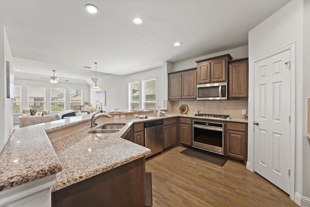 5653 Salt Springs Dr, Fort Worth, TX 76179 - kitchen featuring stainless steel appliances, a sink, wood finished floors, healthy amount of natural light, and recessed lighting