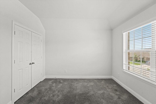 5653 Salt Springs Dr, Fort Worth, TX 76179 - unfurnished bedroom with vaulted ceiling, dark carpet, multiple windows, and baseboards