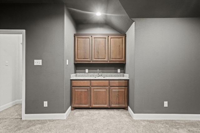 5653 Salt Springs Dr, Fort Worth, TX 76179 - indoor wet bar featuring light colored carpet, vaulted ceiling, and baseboards