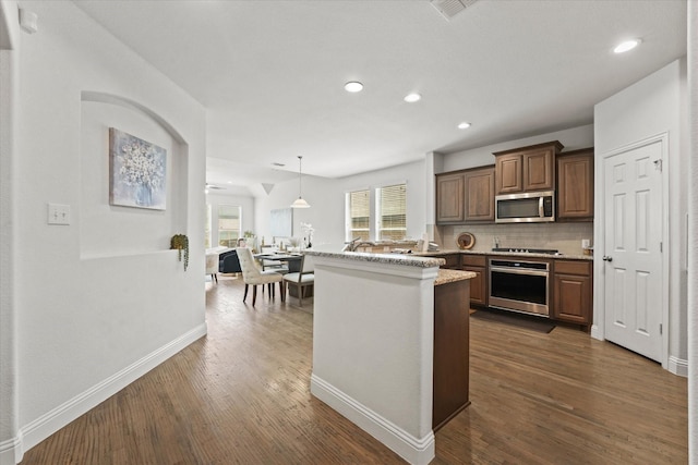 5653 Salt Springs Dr, Fort Worth, TX 76179 - kitchen with appliances with stainless steel finishes, dark wood finished floors, baseboards, recessed lighting, and backsplash