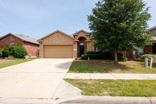 1300 Woodbine Cliff Dr, Fort Worth, TX 76179 - view of front of house with an attached garage, brick siding, driveway, and a front lawn