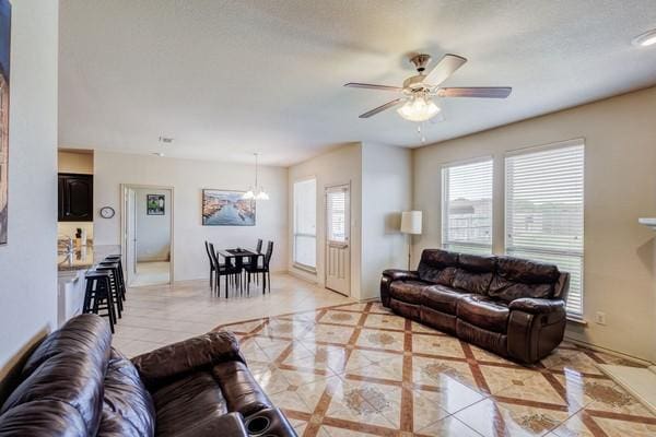 1300 Woodbine Cliff Dr, Fort Worth, TX 76179 - living area with a ceiling fan and a chandelier