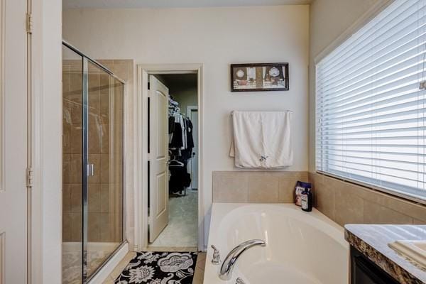 1300 Woodbine Cliff Dr, Fort Worth, TX 76179 - full bathroom featuring a garden tub, a shower stall, a walk in closet, and vanity
