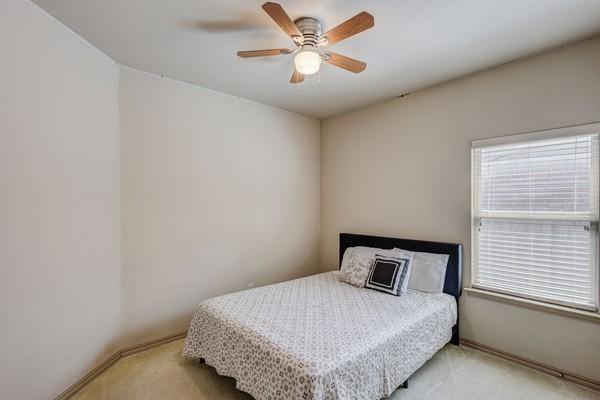 1300 Woodbine Cliff Dr, Fort Worth, TX 76179 - bedroom with light carpet, baseboards, and a ceiling fan