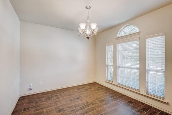 1300 Woodbine Cliff Dr, Fort Worth, TX 76179 - unfurnished room featuring a chandelier, dark wood-style floors, and baseboards