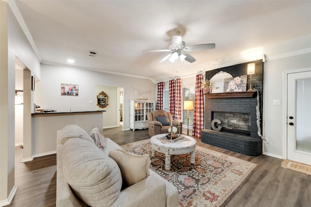 407 W Park Ave, Weatherford, TX 76086 - living room featuring ornamental molding, wood finished floors, baseboards, a ceiling fan, and a fireplace