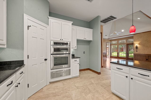6808 N Oaks Dr, North Richland Hills, TX 76182 - kitchen with a warming drawer, stainless steel double oven, white cabinetry, ceiling fan, and dark stone counters