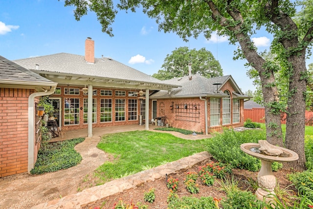 6808 N Oaks Dr, North Richland Hills, TX 76182 - rear view of property featuring brick siding, a patio area, a chimney, and a shingled roof