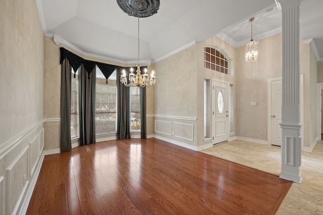 6808 N Oaks Dr, North Richland Hills, TX 76182 - foyer entrance featuring a chandelier, decorative columns, a towering ceiling, crown molding, and wood finished floors