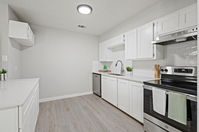 6206 Springwood Dr, Arlington, TX 76001 - kitchen featuring appliances with stainless steel finishes, under cabinet range hood, a sink, light wood finished floors, and light countertops