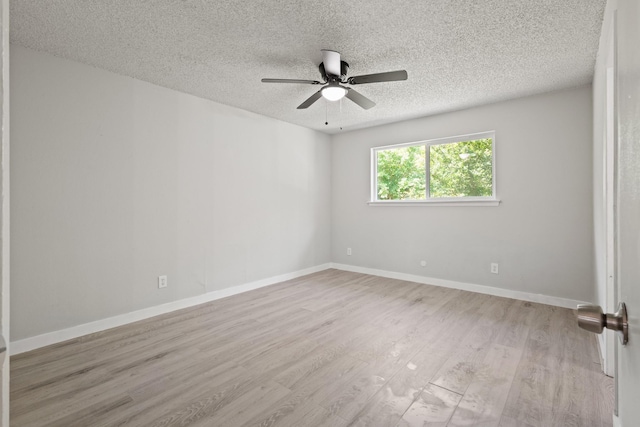 6206 Springwood Dr, Arlington, TX 76001 - spare room with a textured ceiling, wood finished floors, ceiling fan, and baseboards