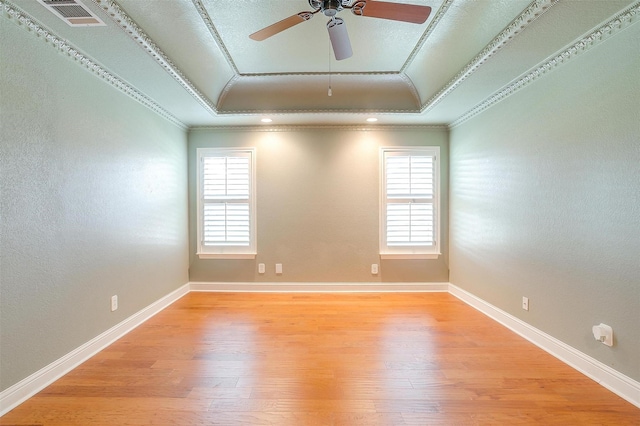 5800 Montford Dr, Colleyville, TX 76034 - spare room with crown molding, a raised ceiling, plenty of natural light, light wood-style floors, and a ceiling fan