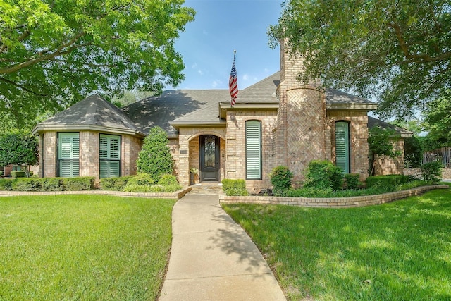 5800 Montford Dr, Colleyville, TX 76034 - view of front of home featuring a front lawn, a chimney, roof with shingles, and brick siding