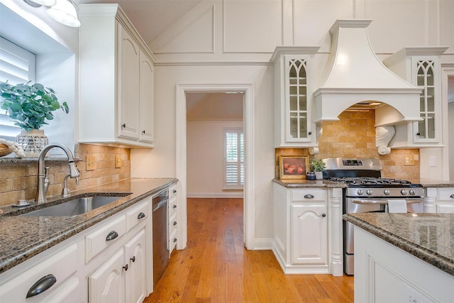 5800 Montford Dr, Colleyville, TX 76034 - kitchen with appliances with stainless steel finishes, a sink, custom range hood, dark stone counters, and white cabinets