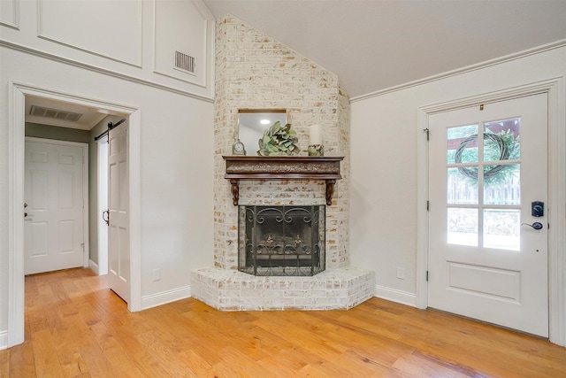 5800 Montford Dr, Colleyville, TX 76034 - unfurnished living room featuring light wood-style flooring, lofted ceiling, a brick fireplace, and baseboards