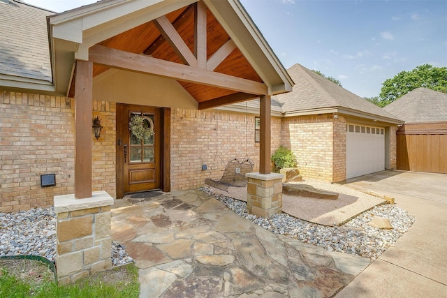 5800 Montford Dr, Colleyville, TX 76034 - property entrance featuring a garage, brick siding, driveway, and roof with shingles
