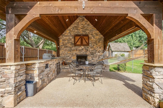 5800 Montford Dr, Colleyville, TX 76034 - view of patio featuring an outdoor stone fireplace and outdoor dining space