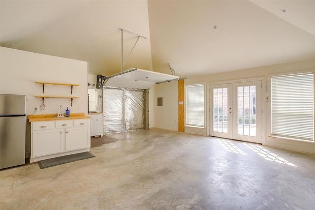 5800 Montford Dr, Colleyville, TX 76034 - garage featuring french doors, freestanding refrigerator, electric panel, and a sink