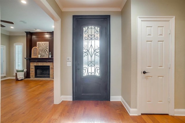 5800 Montford Dr, Colleyville, TX 76034 - foyer with light wood-style floors, a fireplace, crown molding, baseboards, and ceiling fan