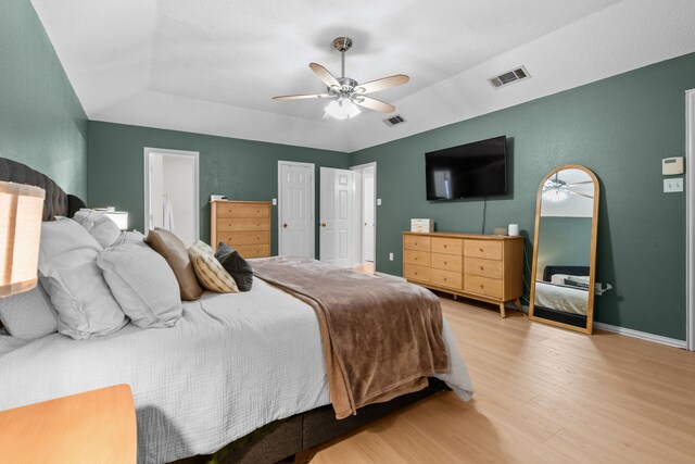 7612 Brittany Pl, Fort Worth, TX 76137 - bedroom with wood finished floors, lofted ceiling, ceiling fan, baseboards, and ensuite bathroom