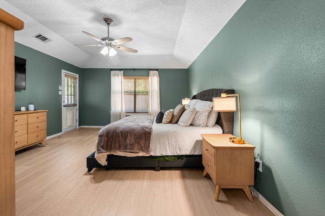 7612 Brittany Pl, Fort Worth, TX 76137 - bedroom featuring wood finished floors, lofted ceiling, baseboards, a textured wall, and a textured ceiling