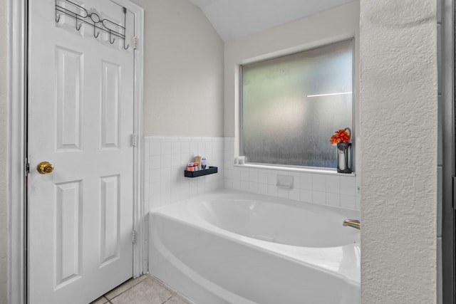 7612 Brittany Pl, Fort Worth, TX 76137 - full bathroom with a garden tub, tile patterned flooring, vaulted ceiling, and a textured wall