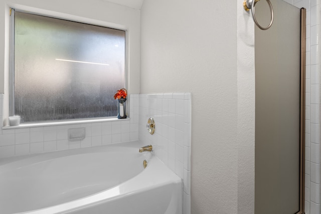 7612 Brittany Pl, Fort Worth, TX 76137 - bathroom featuring a garden tub and a textured wall