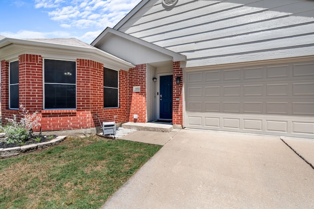 7612 Brittany Pl, Fort Worth, TX 76137 - view of front of home featuring brick siding, driveway, and an attached garage