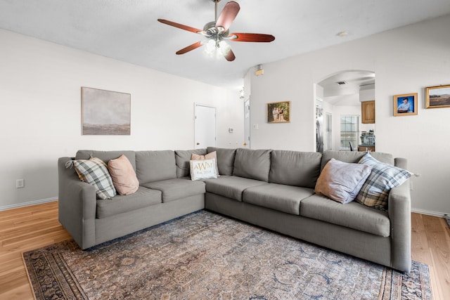7612 Brittany Pl, Fort Worth, TX 76137 - living area with arched walkways, light wood-type flooring, a ceiling fan, and baseboards