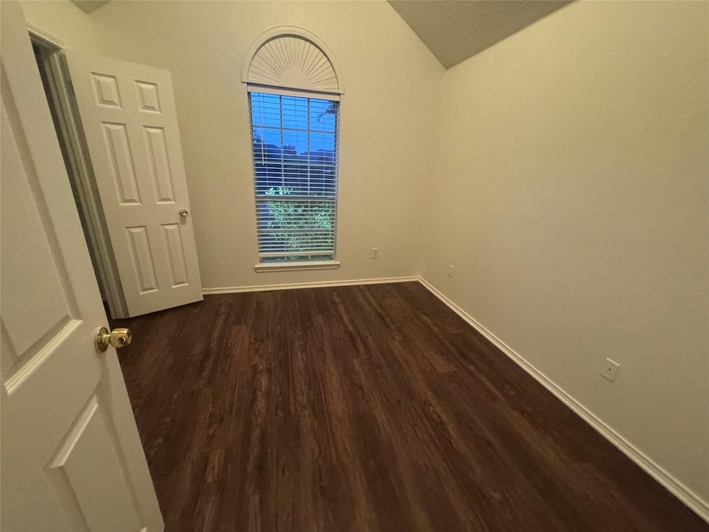 2977 Firewheel Dr, Rockwall, TX 75032 - unfurnished room featuring baseboards, dark wood-style flooring, and lofted ceiling