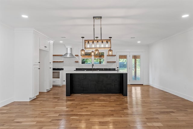 2925 Edmond Ave, Waco, TX 76707 - kitchen with a sink, light wood-style flooring, wall chimney range hood, white cabinets, and recessed lighting