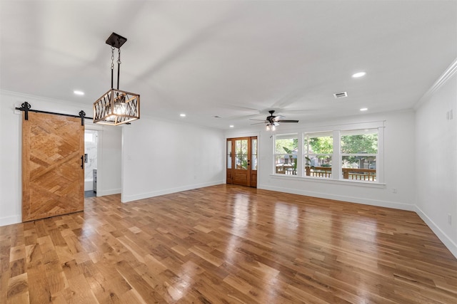 2925 Edmond Ave, Waco, TX 76707 - unfurnished living room featuring a barn door, ornamental molding, recessed lighting, a ceiling fan, and light wood-style floors