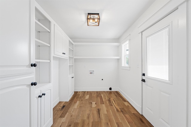 2925 Edmond Ave, Waco, TX 76707 - washroom featuring hookup for an electric dryer, hookup for a washing machine, light wood-type flooring, cabinet space, and baseboards