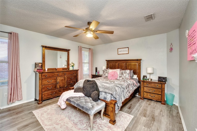 1209 Starpoint Ln, Wylie, TX 75098 - bedroom featuring light wood-style floors, a textured ceiling, baseboards, and a ceiling fan