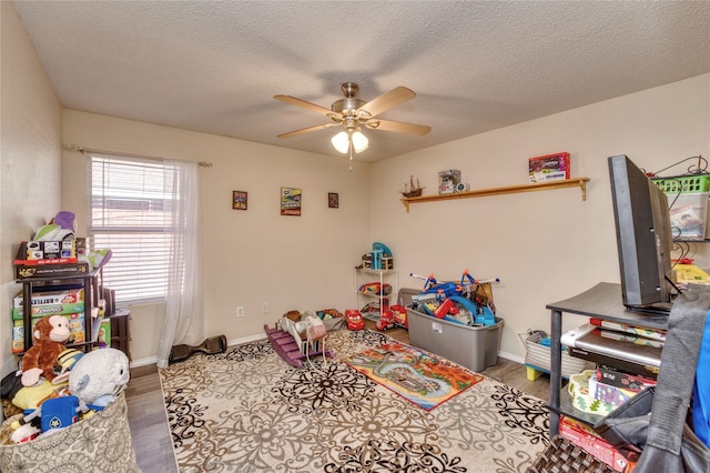 1209 Starpoint Ln, Wylie, TX 75098 - recreation room featuring a ceiling fan, wood finished floors, baseboards, and a textured ceiling