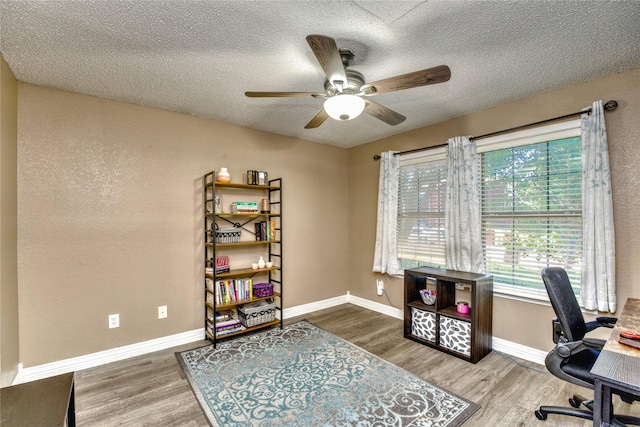 1209 Starpoint Ln, Wylie, TX 75098 - office area featuring wood finished floors, ceiling fan, a textured ceiling, and baseboards