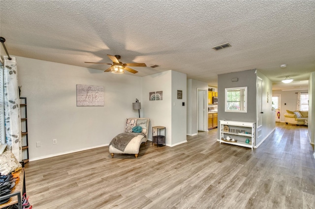 1209 Starpoint Ln, Wylie, TX 75098 - sitting room featuring wood finished floors, ceiling fan, a textured ceiling, and baseboards