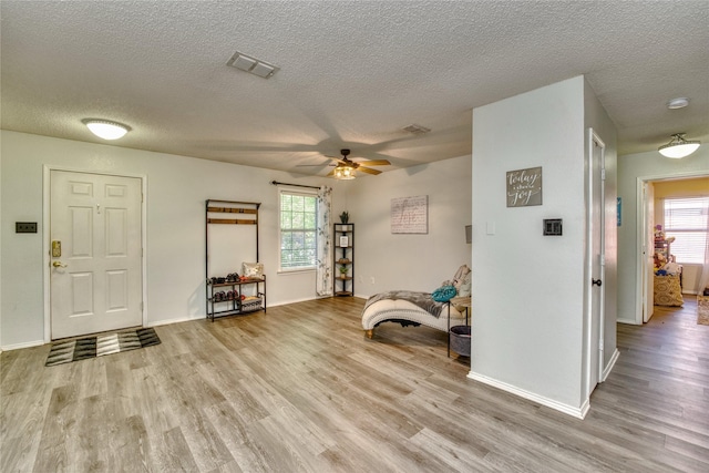 1209 Starpoint Ln, Wylie, TX 75098 - foyer entrance with wood finished floors, a textured ceiling, ceiling fan, and baseboards
