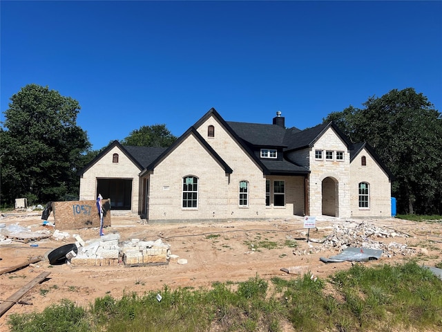 1057 Llano Way, Poolville, TX 76487 - french country home with a chimney, brick siding, and stone siding