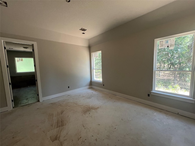 1057 Llano Way, Poolville, TX 76487 - spare room with baseboards and unfinished concrete flooring