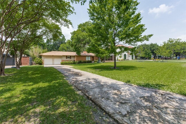 8523 Santa Clara Dr, Dallas, TX 75218 - view of front of property with a front yard, an attached garage, a chimney, and driveway