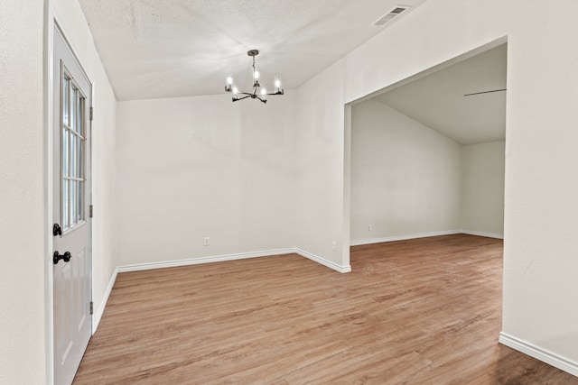 8810 Sugarberry Rd, Dallas, TX 75249 - unfurnished dining area with a chandelier, light wood-style floors, and baseboards