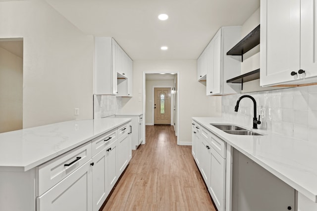 8810 Sugarberry Rd, Dallas, TX 75249 - kitchen featuring a sink, baseboards, light wood-style flooring, recessed lighting, and tasteful backsplash