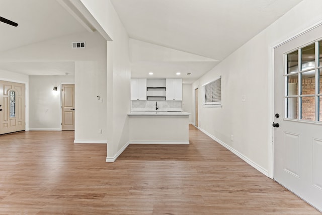 8810 Sugarberry Rd, Dallas, TX 75249 - unfurnished living room featuring vaulted ceiling, light wood-type flooring, baseboards, a sink, and recessed lighting