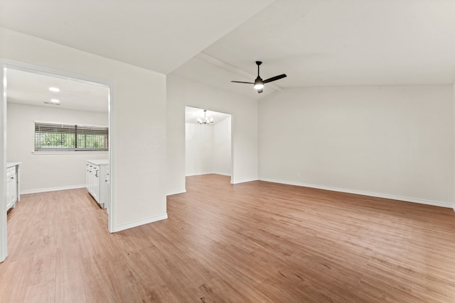 8810 Sugarberry Rd, Dallas, TX 75249 - empty room with light wood finished floors, baseboards, a chandelier, ceiling fan, and vaulted ceiling