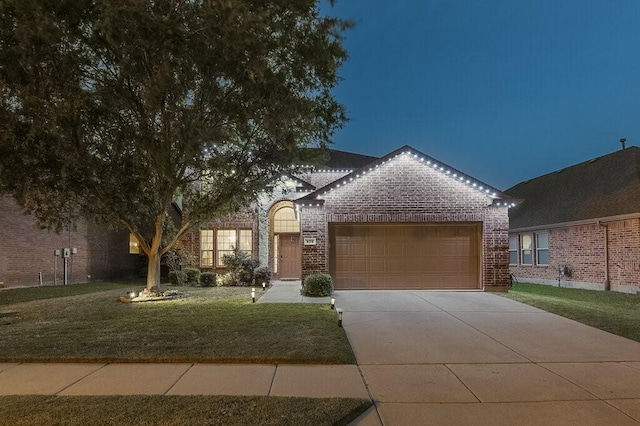 925 Lake Grove Dr, Little Elm, TX 75068 - view of front of property with brick siding, a garage, driveway, and a front lawn