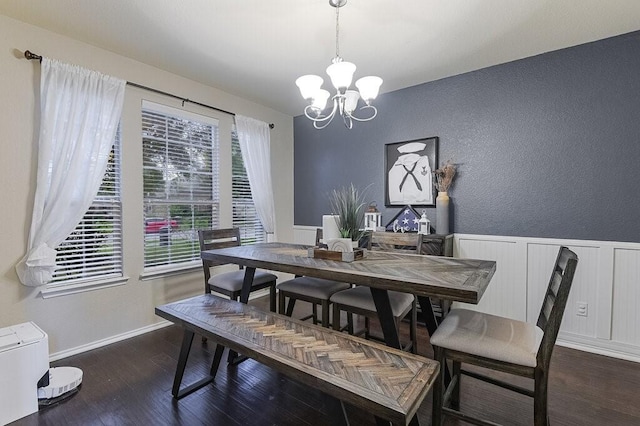 925 Lake Grove Dr, Little Elm, TX 75068 - dining space featuring a chandelier, wood finished floors, a textured wall, and a wainscoted wall