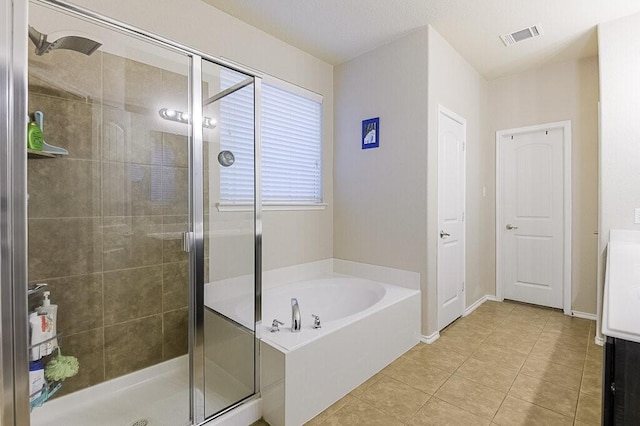 925 Lake Grove Dr, Little Elm, TX 75068 - bathroom featuring a garden tub, a shower stall, tile patterned floors, and baseboards