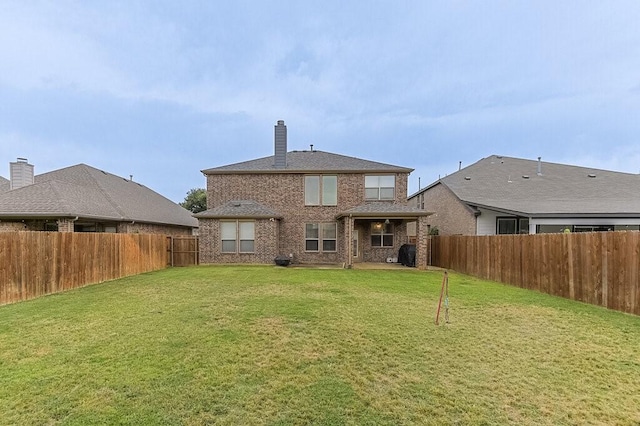 925 Lake Grove Dr, Little Elm, TX 75068 - back of house featuring brick siding and a chimney